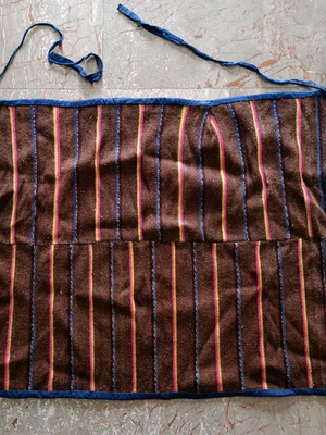 Traditional brown apron with stripes used