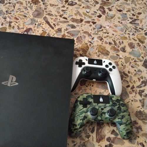 PS4 Pro console with 3 games and 2 controllers
