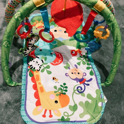 Fisher Price colorful activity gym for newborns used with extra toys