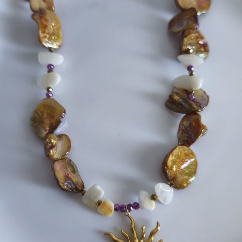 Necklace with mother of pearl and gold steel sun pendant