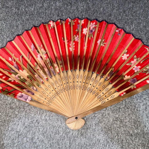 Wooden fan used, red with sakura blossoms