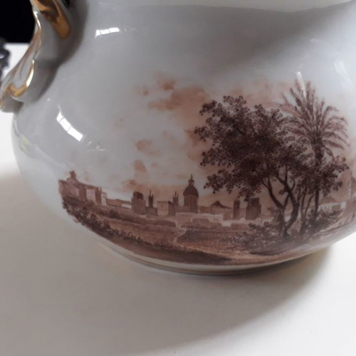 Antique porcelain teapot with wooden handle used
