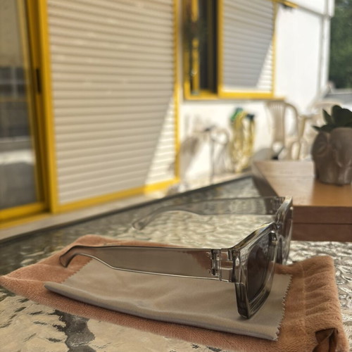 Sunglasses like new with gray semi-transparent frame, cloth and velvet case