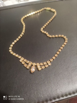 Necklace new, excellent quality with faint orange stones