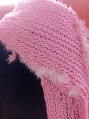 Pink knitted scarf used with fringed ends