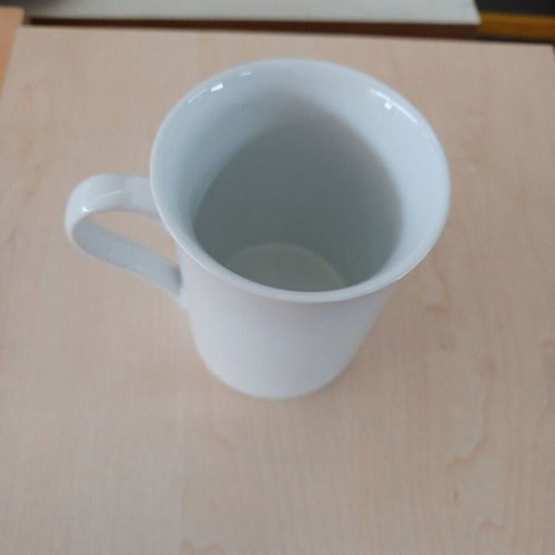 Ceramic white cylindrical mug used