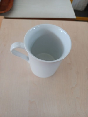 Ceramic white cylindrical mug used