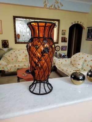 Glass vase used with metal trim