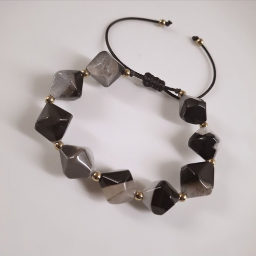 Handmade bracelet with natural black and gray stones and gold details
