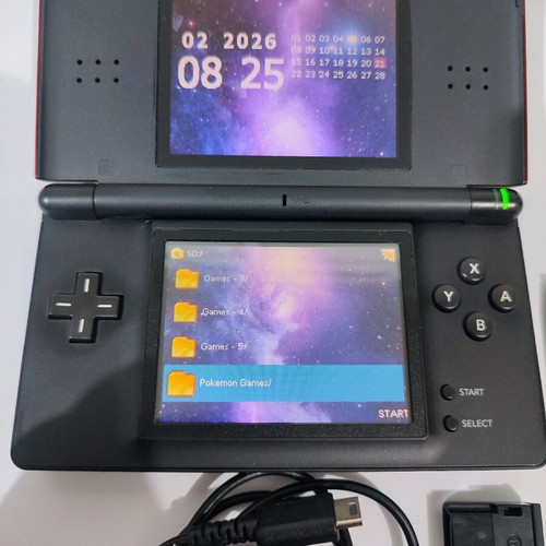 Nintendo DS Lite console used with Pokemon LeafGreen cartridge and accessories