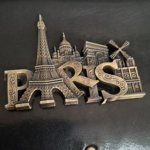 Metal souvenir magnet with Paris theme, gold color