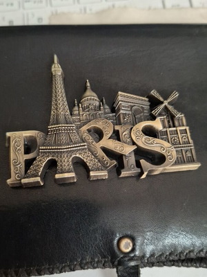 Metal souvenir magnet with Paris theme, gold color