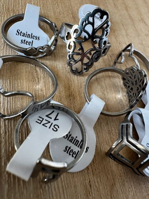 Steel ring set with hearts, geometric and floral designs