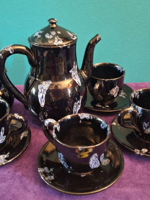 Black ceramic tea set used with minor chips