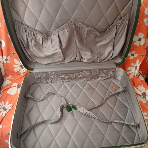 Vintage suitcase used with dark green color and quilted lining