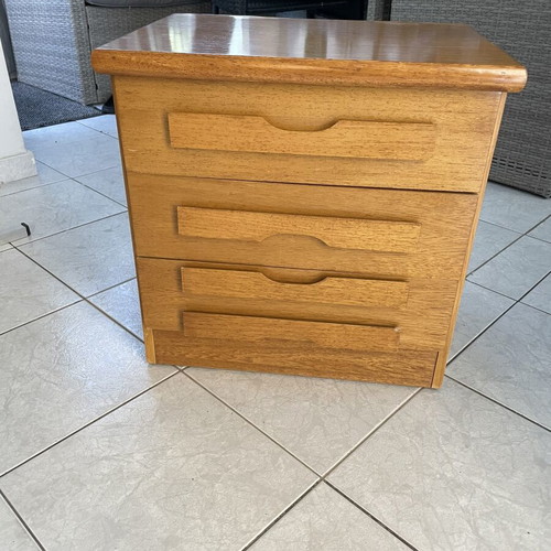 Classic wooden bedside table with three drawers used