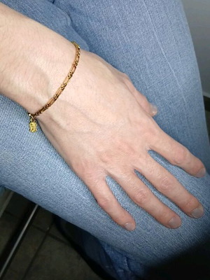 Gold steel chain bracelet with charm