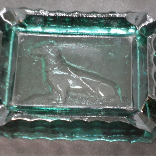 Antique ashtrays pair used with embossed dogs in dark green glass