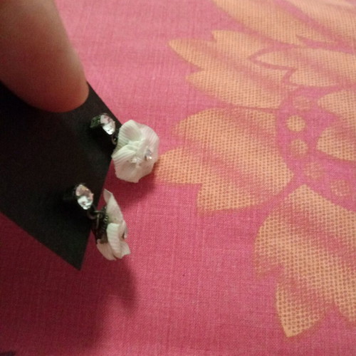 Fwo earrings with white fabric flowers and rhinestones hanging, unworn
