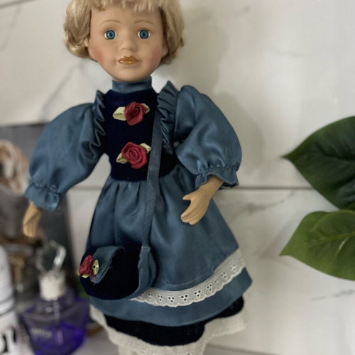 Porcelain doll like new vintage with blue satin dress