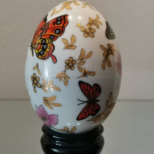 Porcelain egg used with butterflies and wooden base