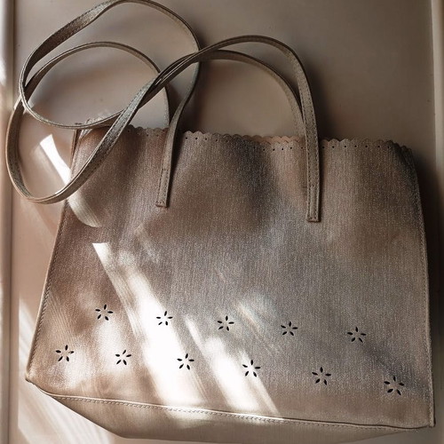 Women's shoulder bag metallic silver with flower cutouts