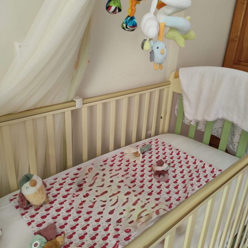Pali Baby Cot used with mosquito net, bumper, and mattress