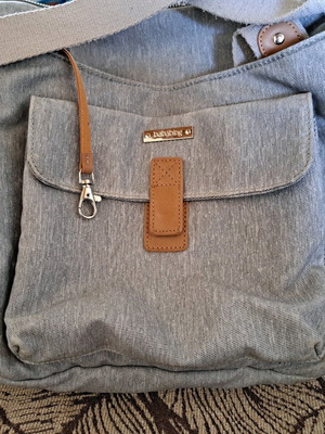 Changing bag used with multiple compartments and detachable changing mat