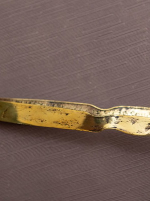 Bronze tongs with boot-shaped ends used