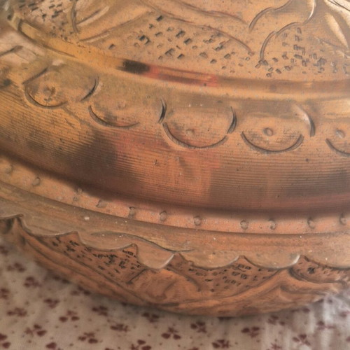 Traditional copper vessel with carved lid used