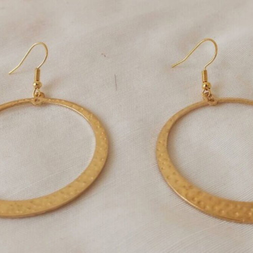 Large gold-tone hoop earrings with embossed hammered surface
