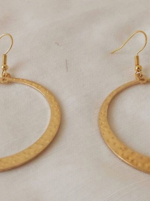 Large gold-tone hoop earrings with embossed hammered surface