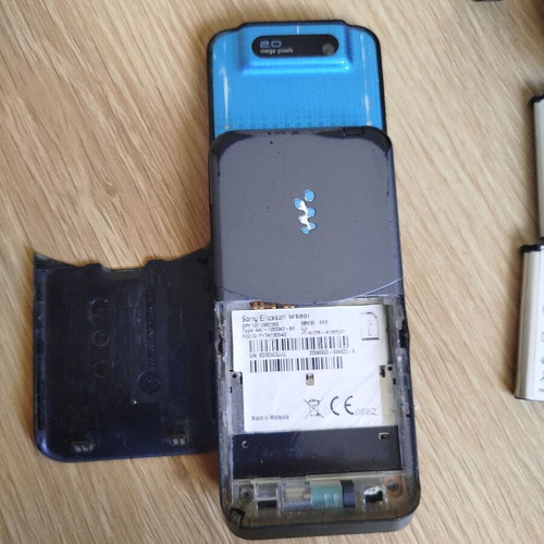 Sony Ericsson w580i used for parts with charger, headphones, and batteries