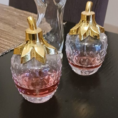 Various perfume bottles used, two with strawberry scent