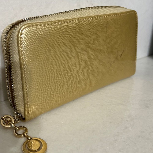 Two gold wallets, one with wrist strap