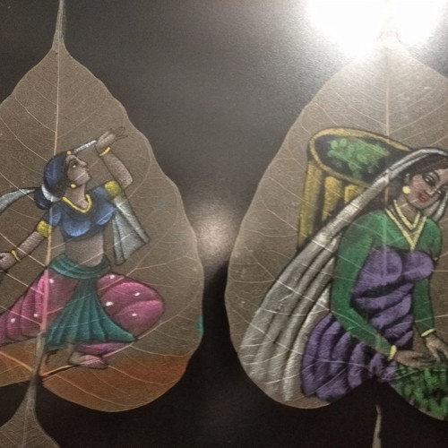 Painting with African figures hand-painted on dried leaves with gold frame and glass