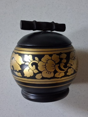 Wooden box with painted designs used, round black with gold flowers