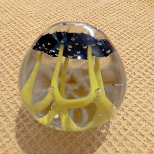 Vintage glass paperweight with yellow dome design