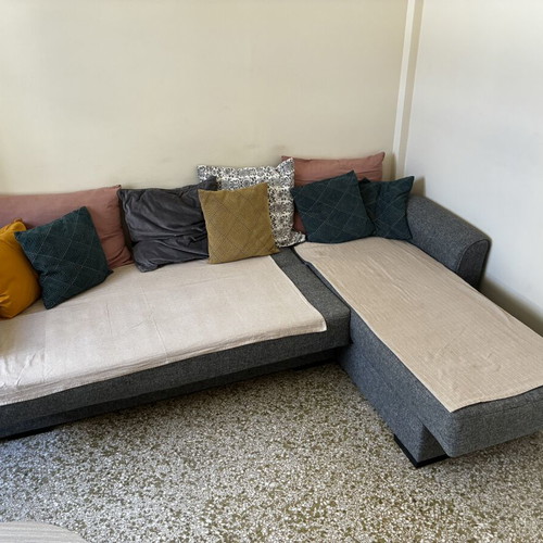Corner sofa bed with storage compartments