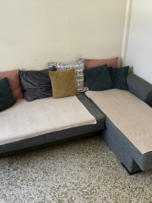 Corner sofa bed with storage compartments