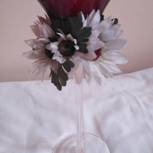 Glass candlestick used with floral wreath and burgundy candle