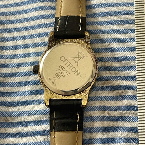 Citron wristwatch used with gold color and black strap