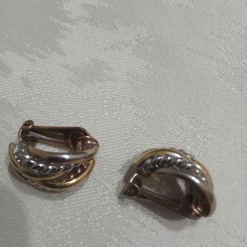 Ornate two-tone earrings used, gold and silver color