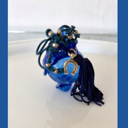 Handmade glass lucky charm in blue shades with horseshoe and silk tassel