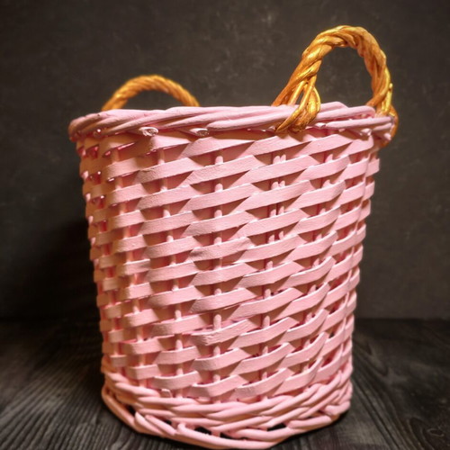 Decorative pink rattan basket with gold handles, handmade