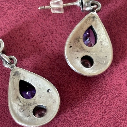 Silver earrings used with purple stones
