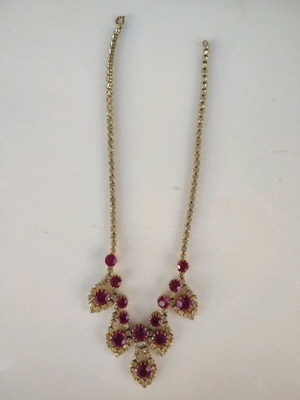 Antique necklace used with pink stones and gold rhinestones