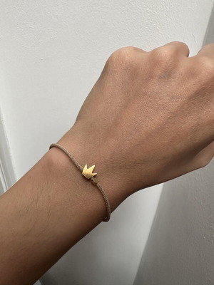 Bracelet crown on beige cord like new with gold details
