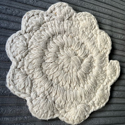 Knitted coaster used, flower-shaped, beige