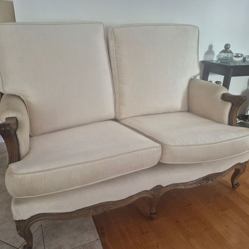 Handmade carved walnut loveseat with cream velvet fabric